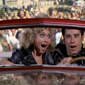 Sandy Olsson & Danny Zuko in Grease in Red Car