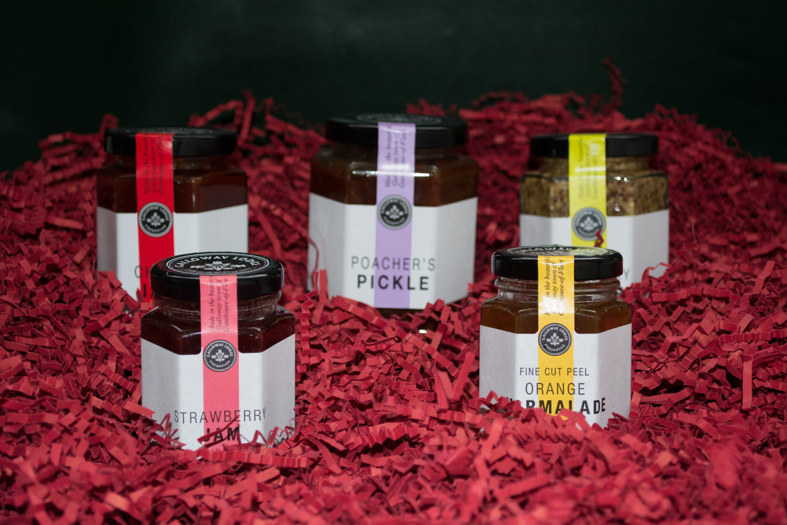 Jars of Galloway Lodge Preserves on Shredded Red Packaging