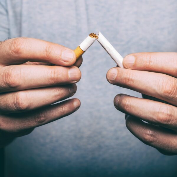 Man Snapping Cigarette in Half