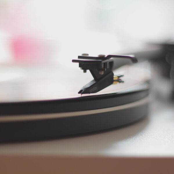 Vinyl record being played on turntable with needle on it