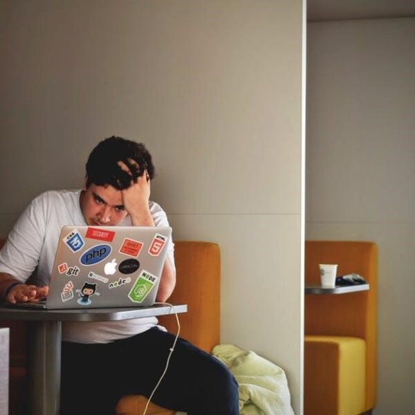 Overworked man using MacBook