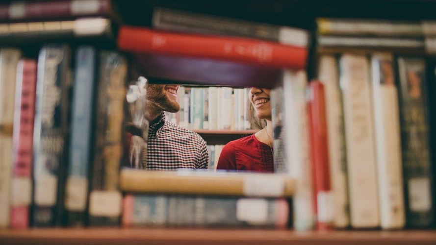 Man and woman talking in a library