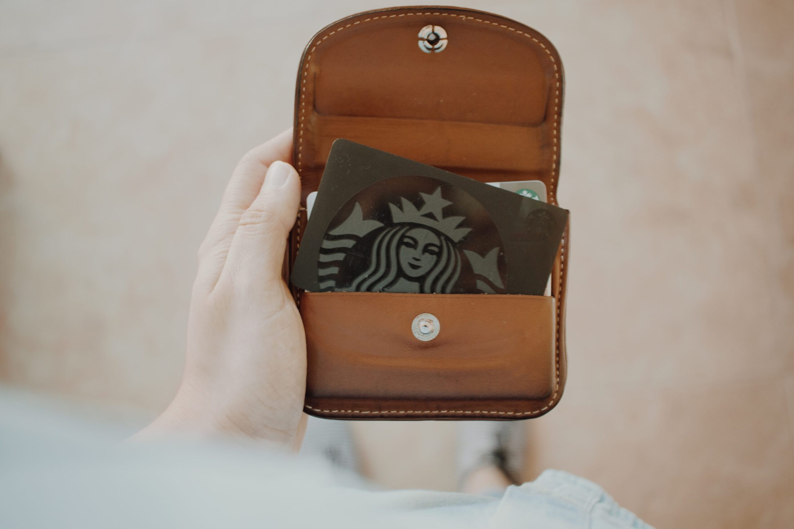 Starbucks gift card inside brown leather wallet