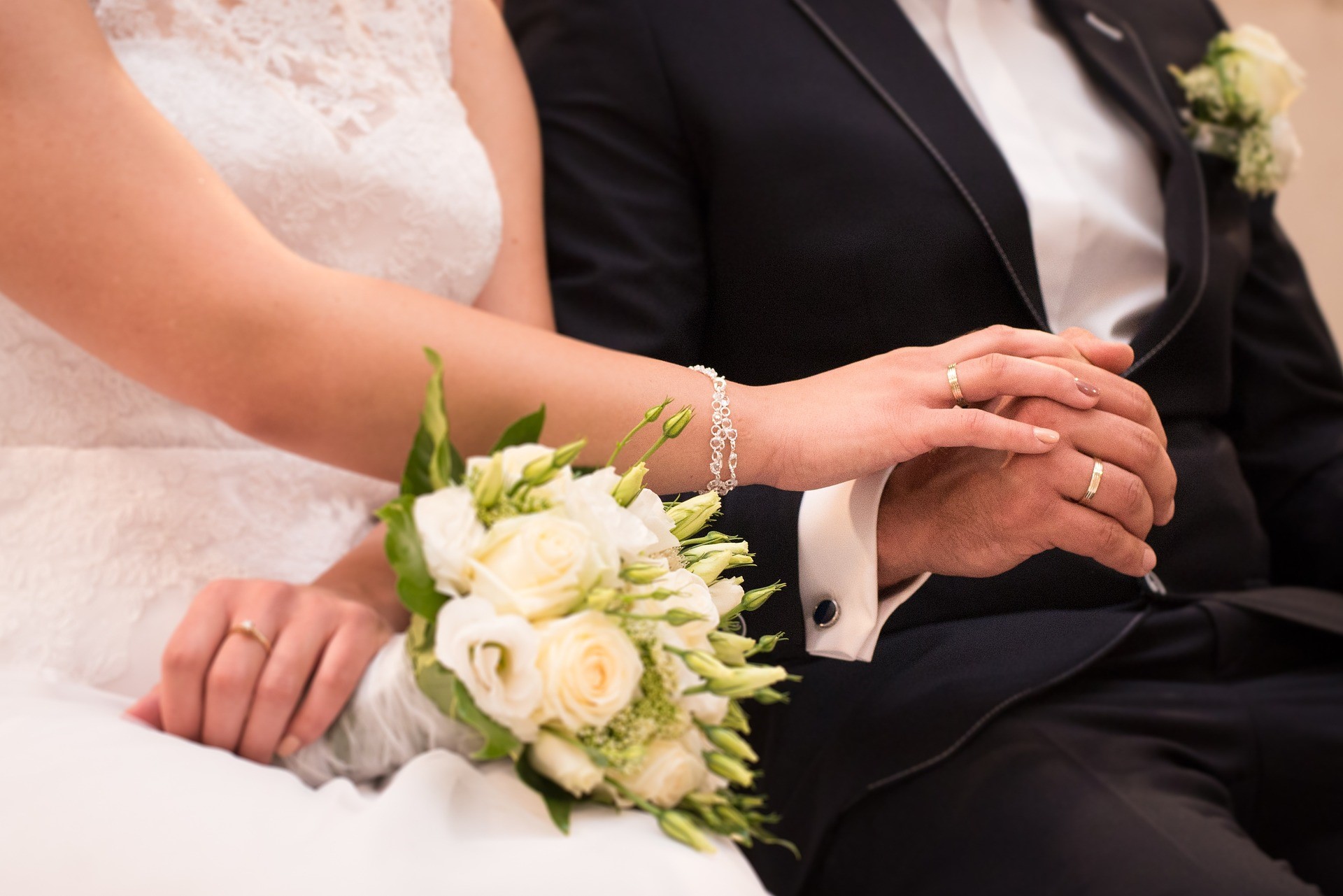 Bride holding groom's hand