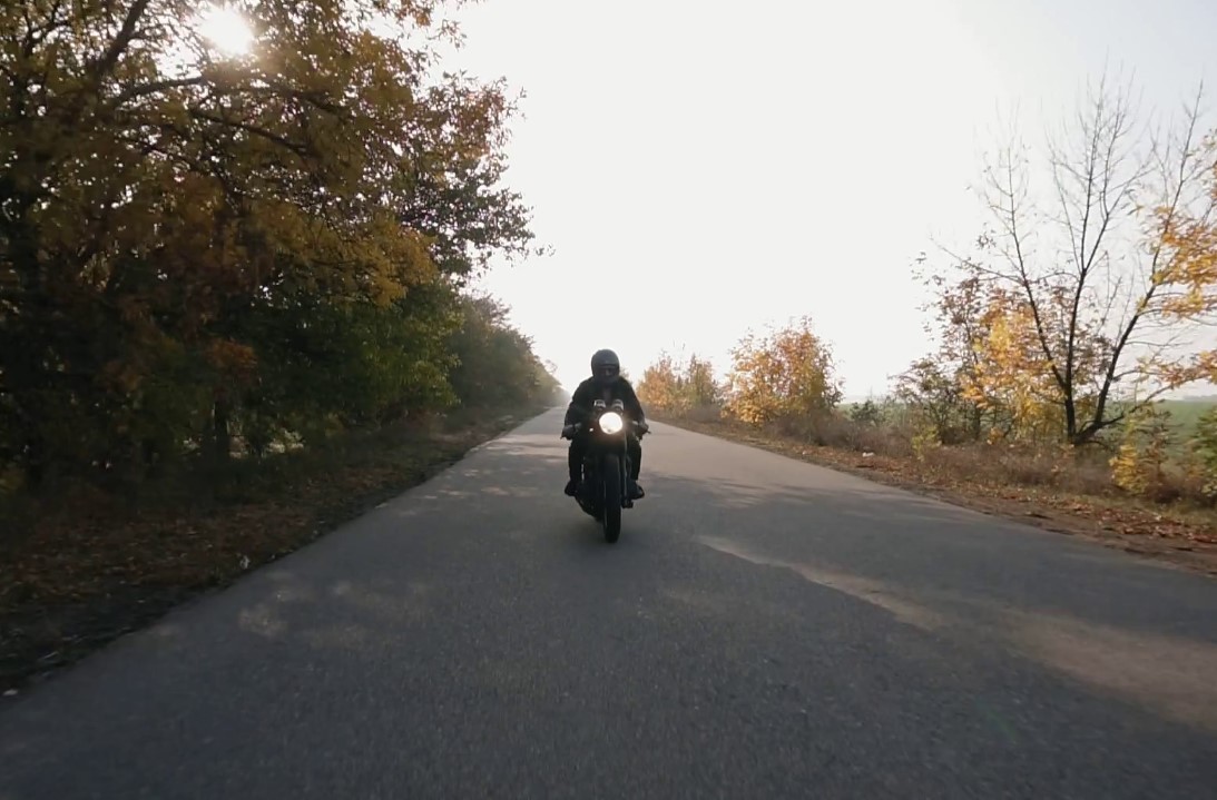Person riding motorcycle with jacket
