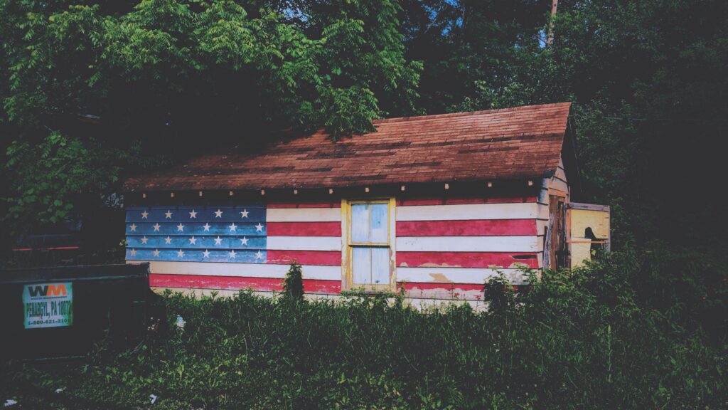Wooden house painted with American flag