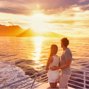 Couple on a boat looking at sunrise