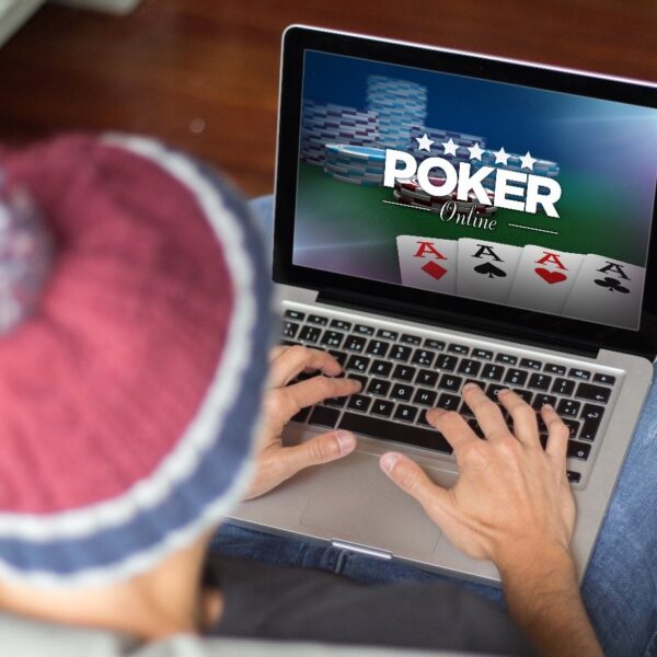 Person playing online poker on laptop