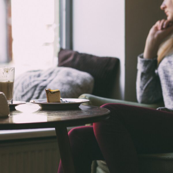 Woman sat with coffee and cake