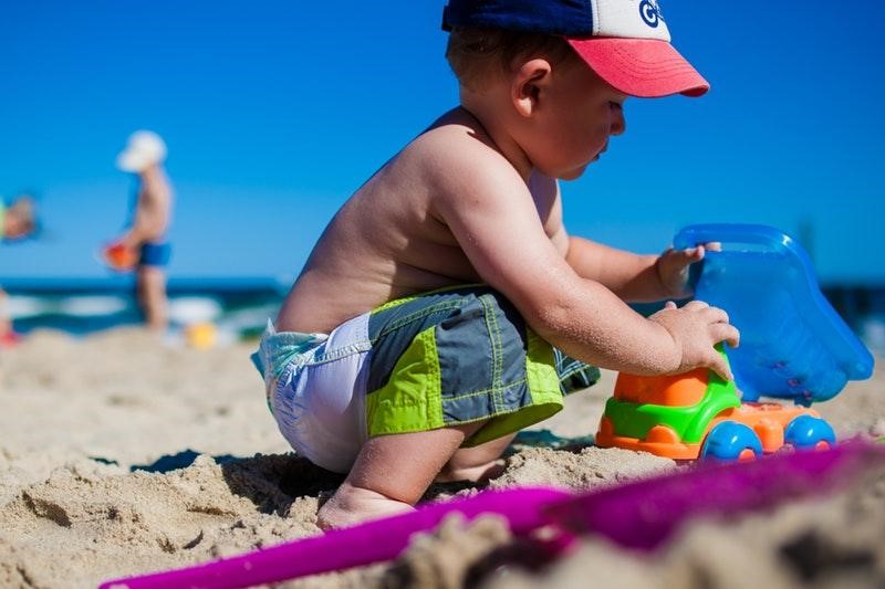Boy playing with toys on the beach