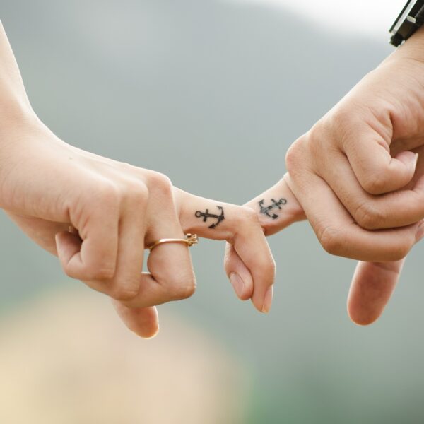 Two people linking fingers