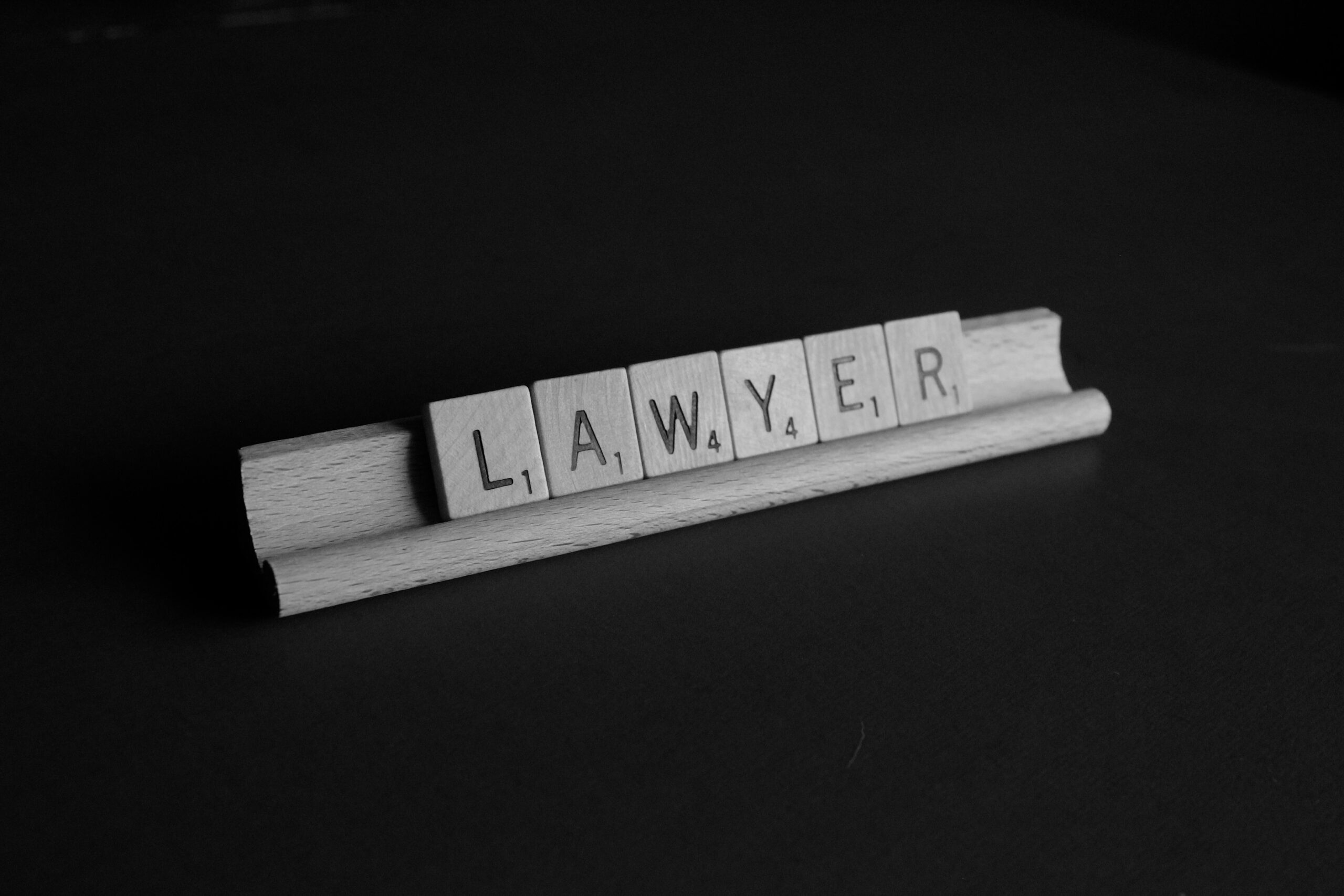 Scrabble tiles spelling 'lawyer'