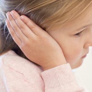 Little girl covering her ear