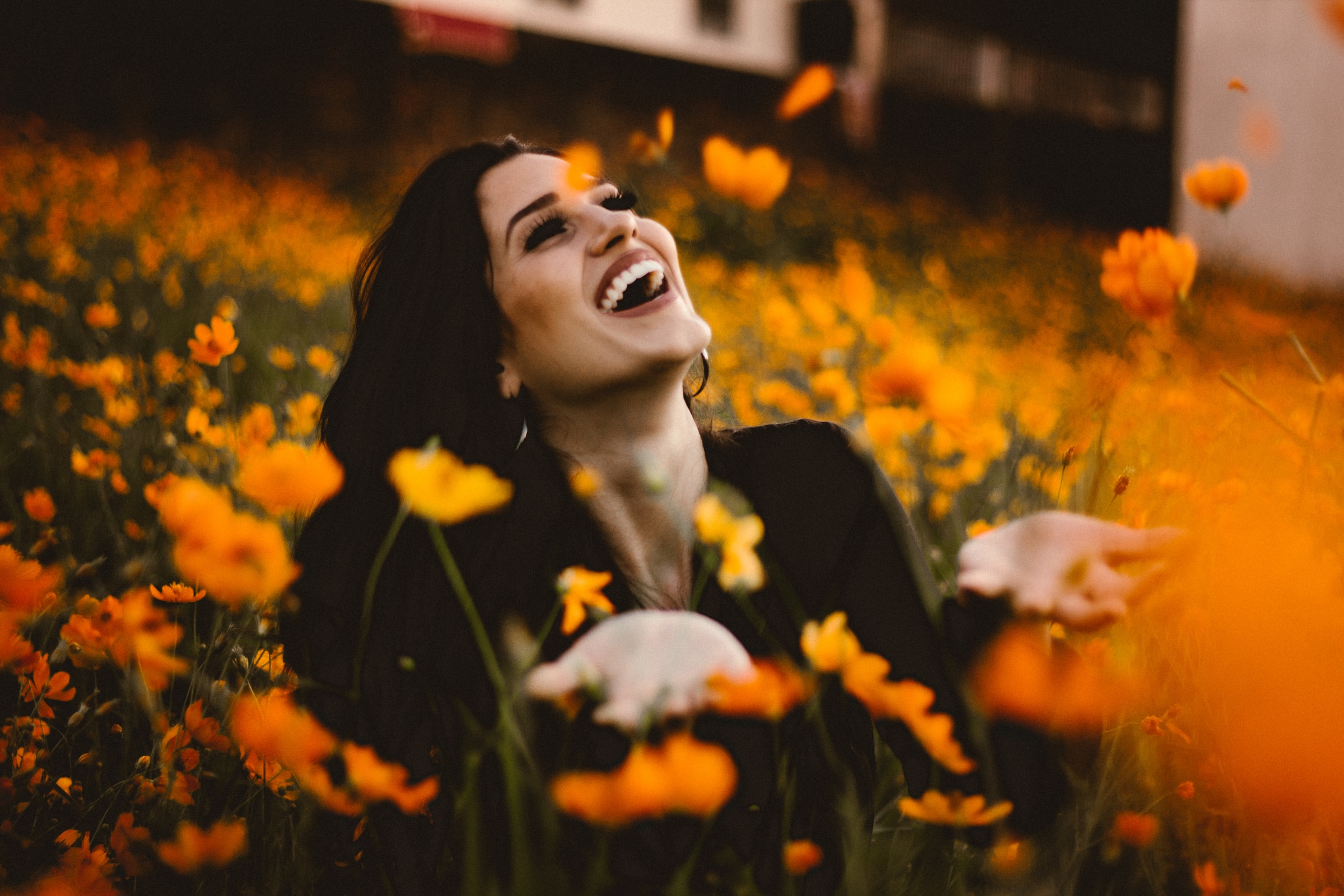 Woman smiling surrounded by flowers