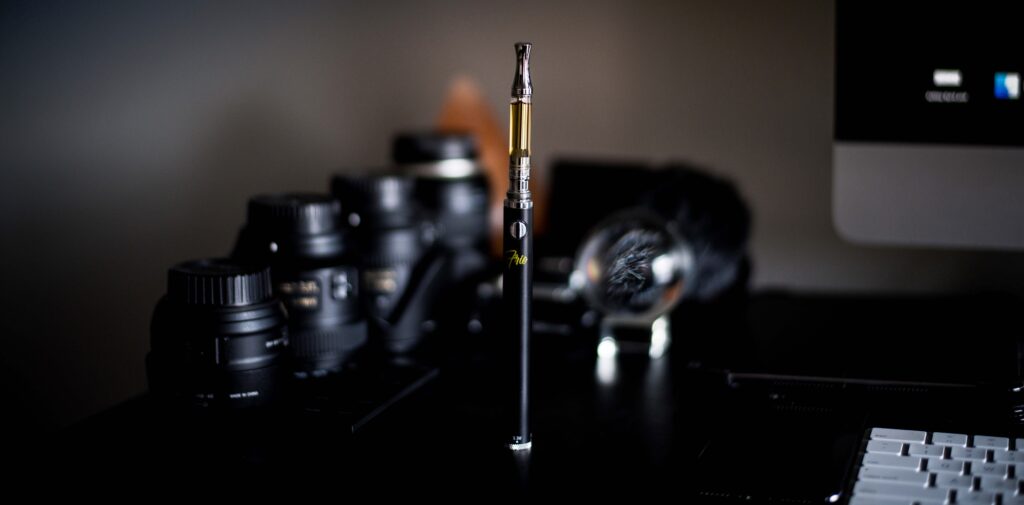 Shallow focus photograph of vape pen on desk