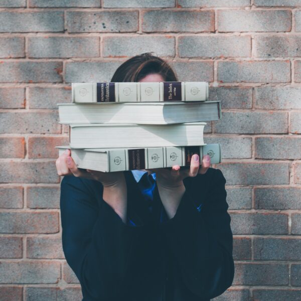 Person holding books in front of their face