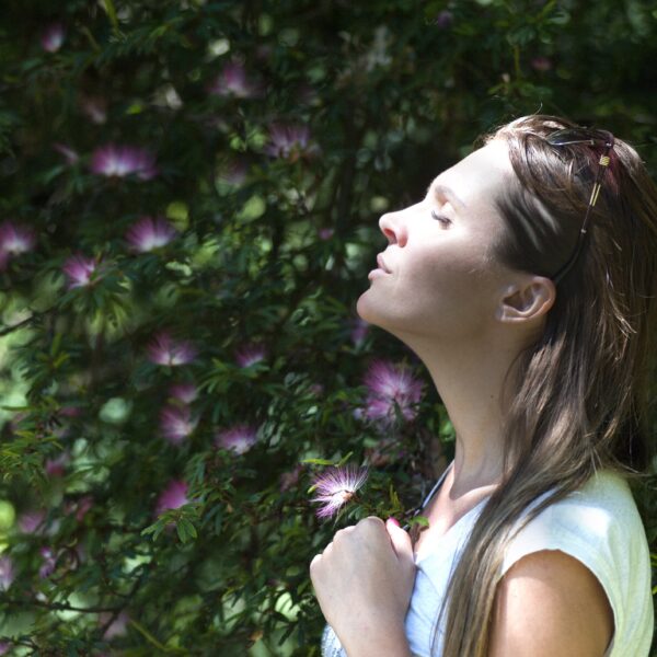 Woman smelling flowers outdoors