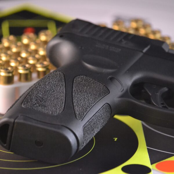 Taurus G3 9mm pistol with targets and bullets in the background