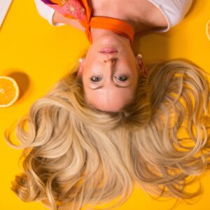 Woman lying on an orange surface