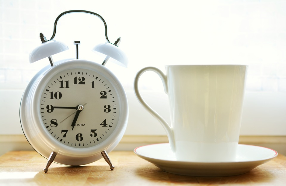 Alarm clock, cup and saucer