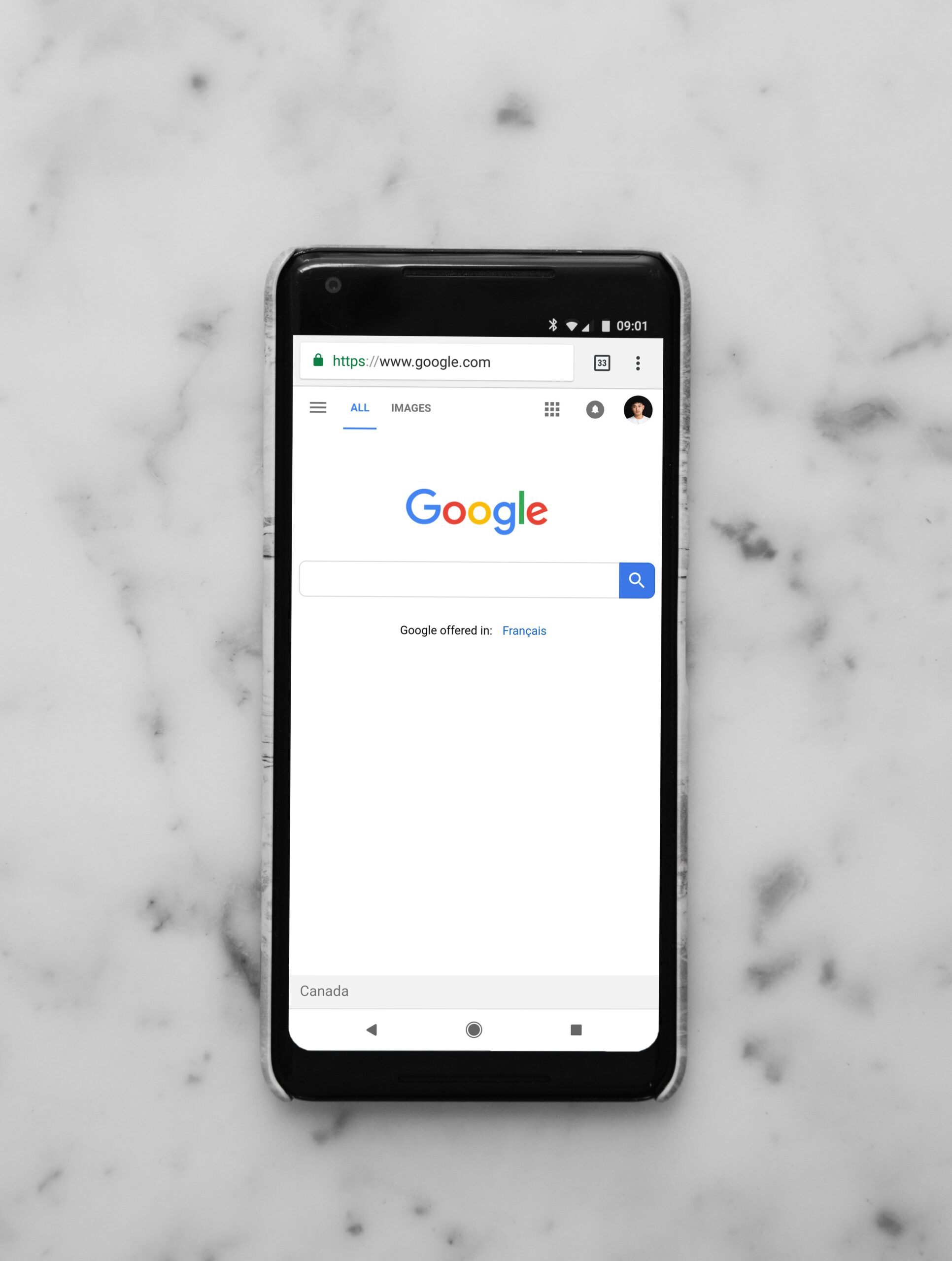 Black Android phone showing Google website