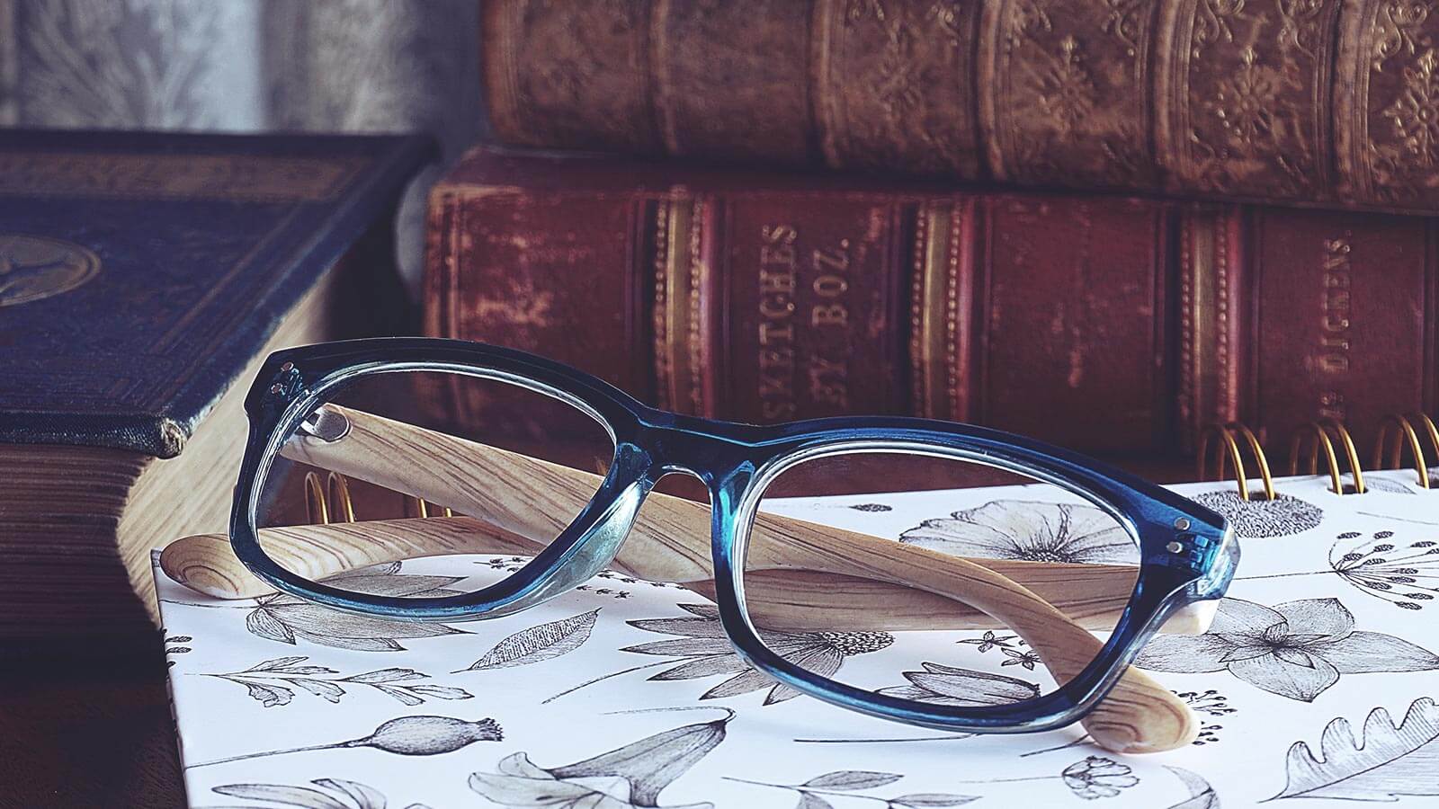 Glasses next to books