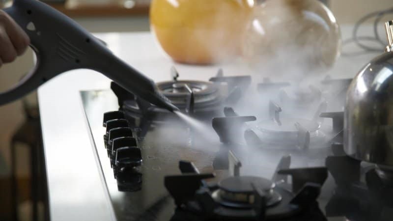 Steam cleaning a stove