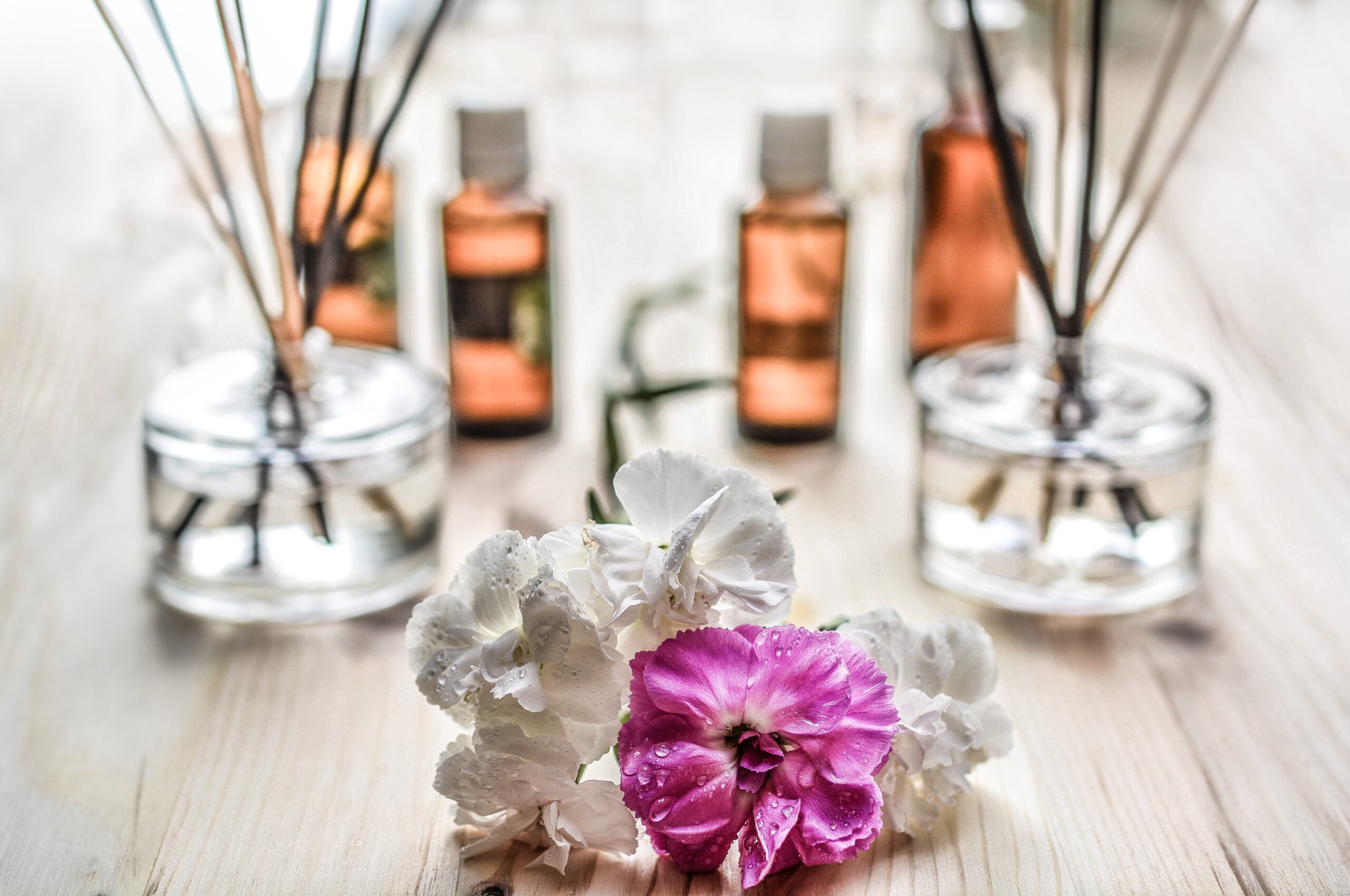 Flowers, bottles of essential oils, and essential oil diffusers