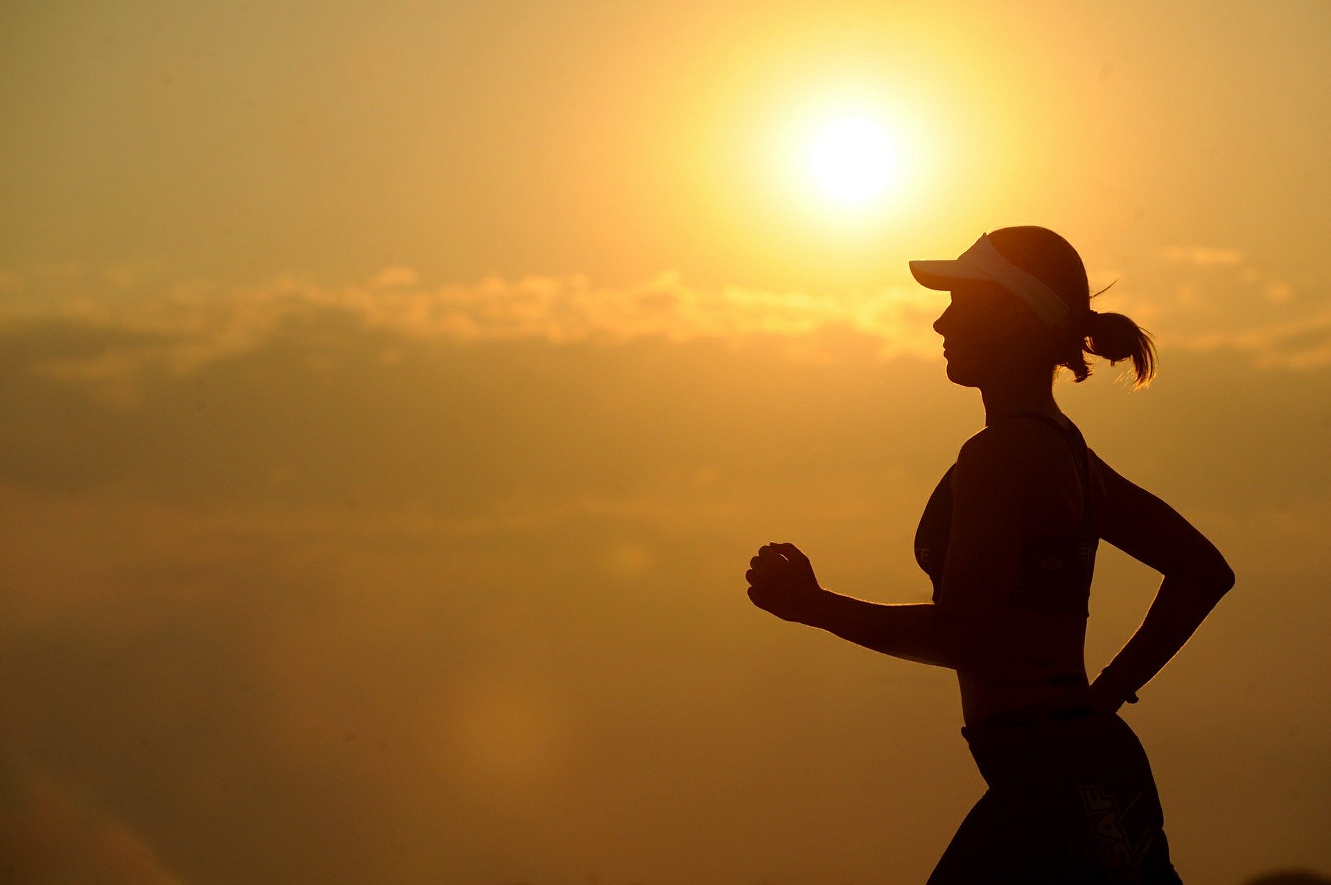 Silhouette of a woman going for a run