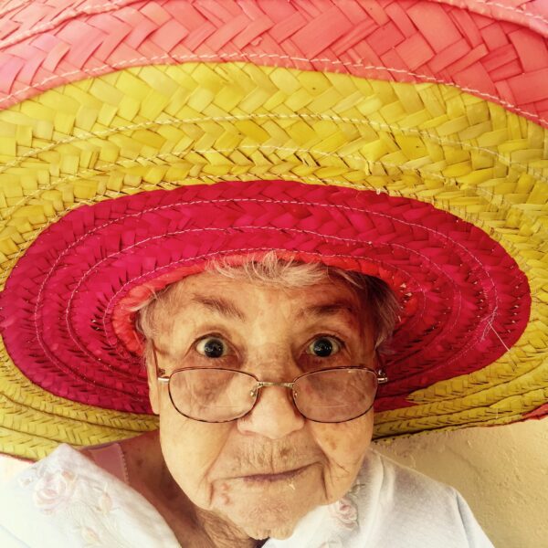 Elderly woman wearing a hat and glasses