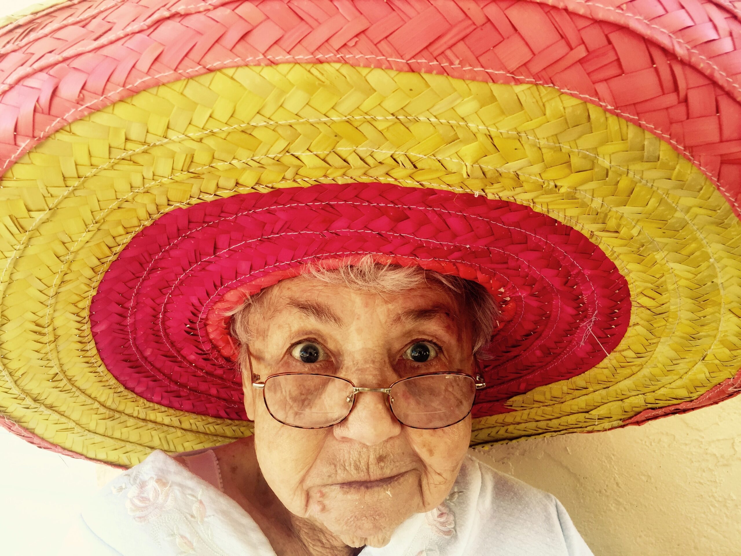 Elderly woman wearing a hat and glasses