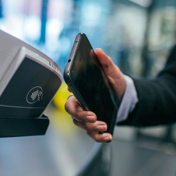 Person using phone to make contactless payment