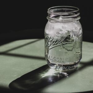 Mason jar with water and ice in it