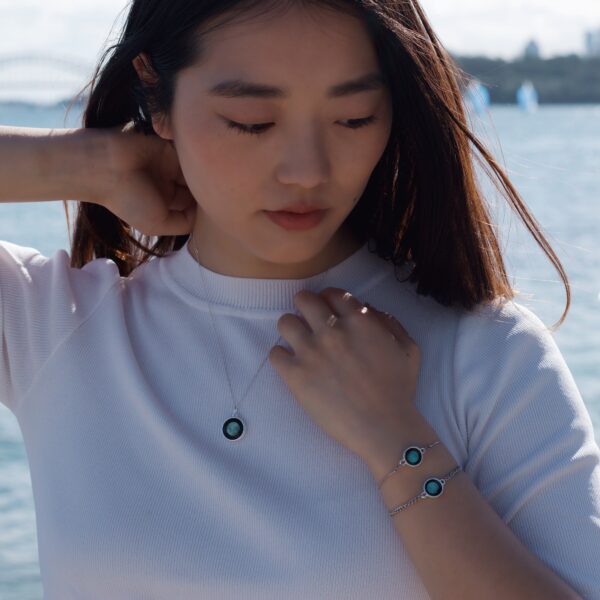 Woman modelling for a jewellery photoshoot for Moonglow Australia at Milk Beach, Sydney, Australia