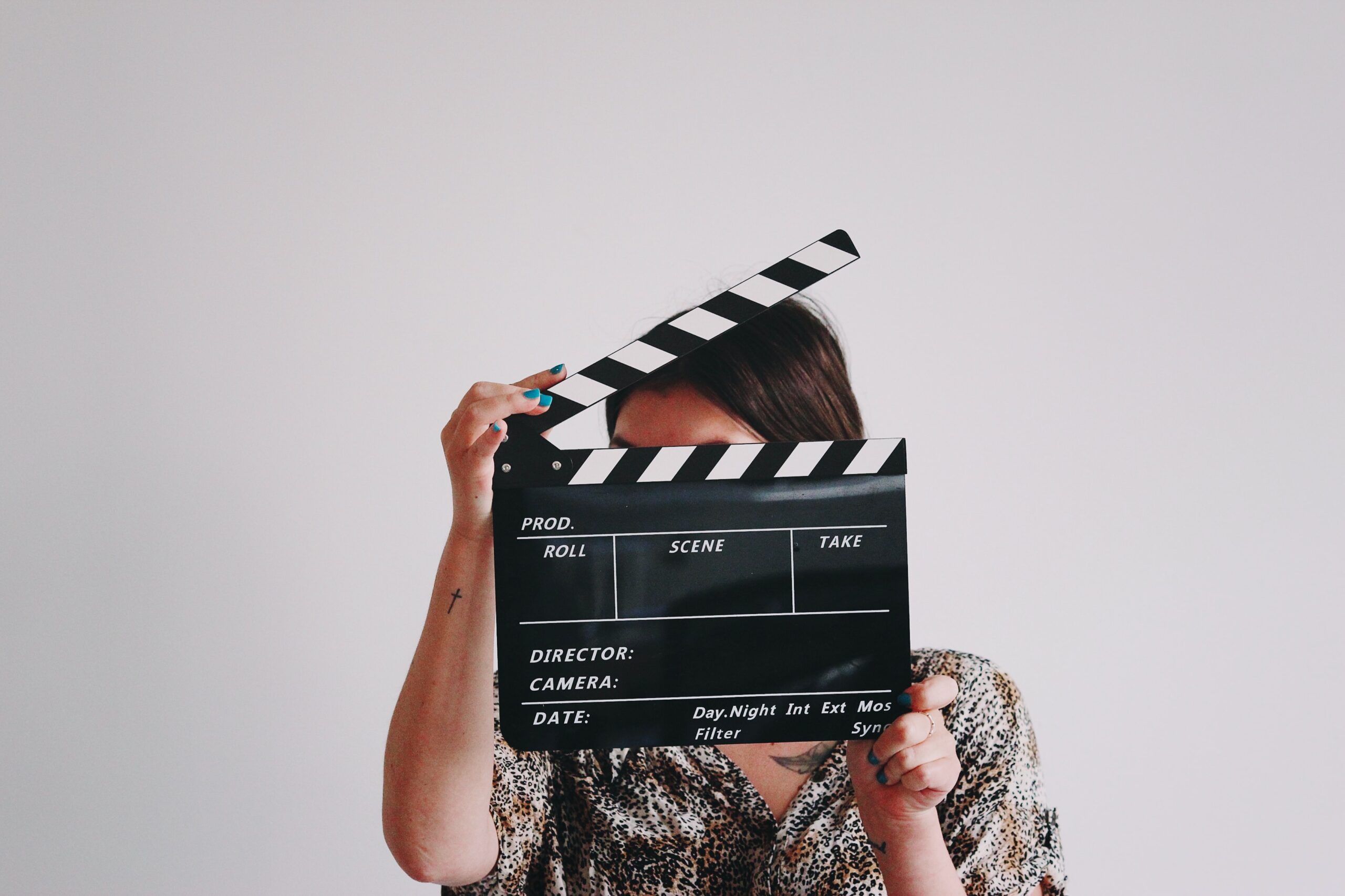 Woman holding clapperboard
