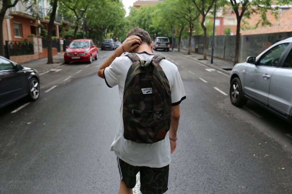 Teen walking down street in Spain