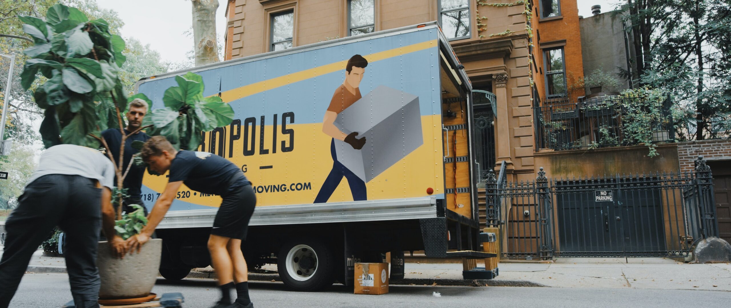 Moving men in front of a moving van