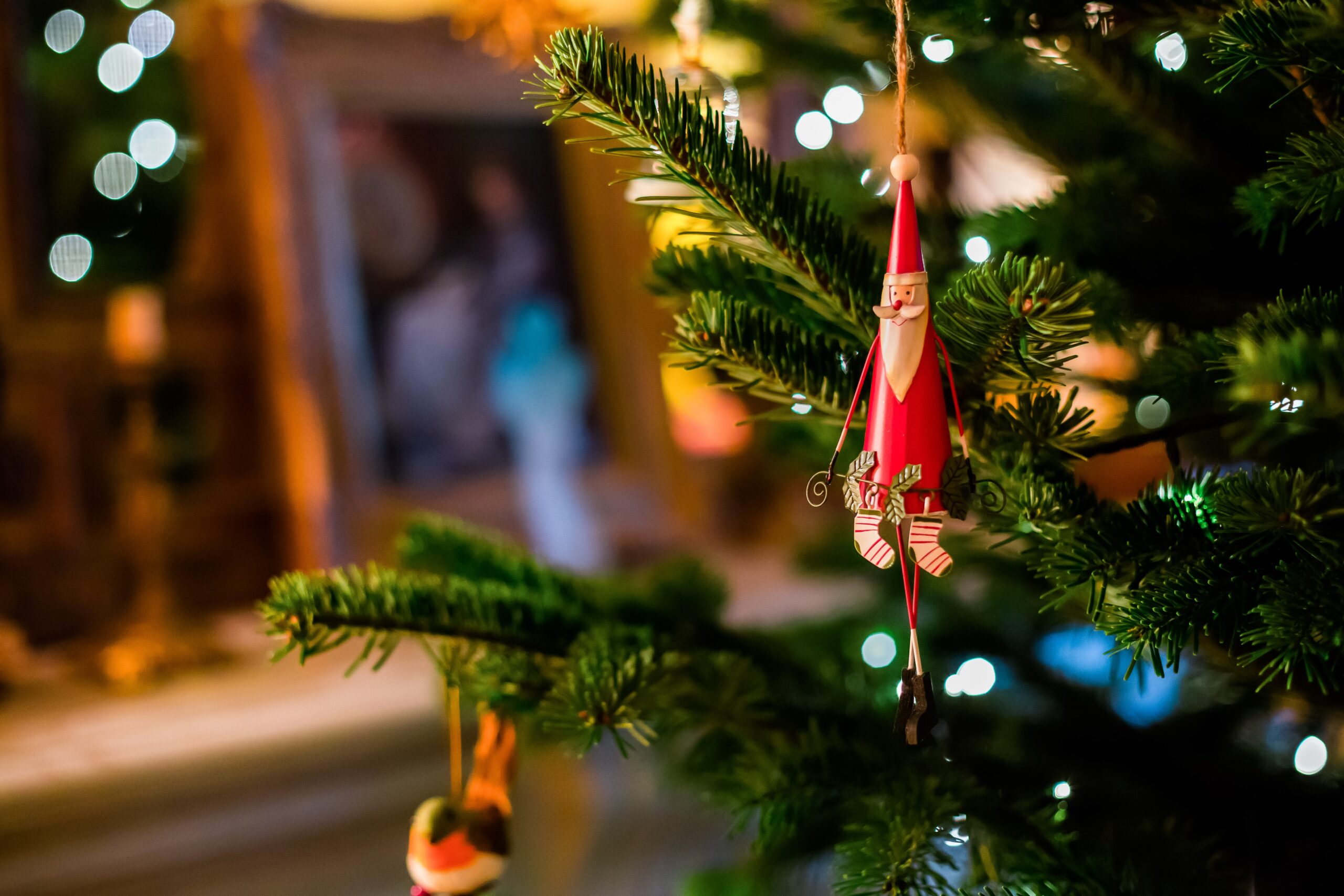 Santa Claus decoration hanging on a Christmas tree