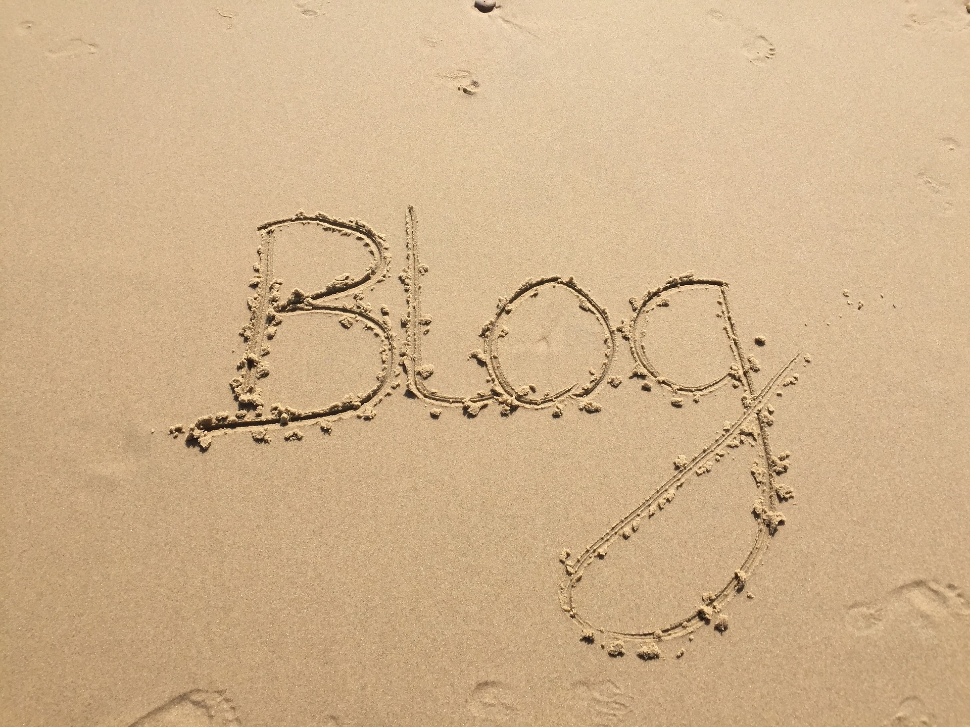'Blog' written in sand