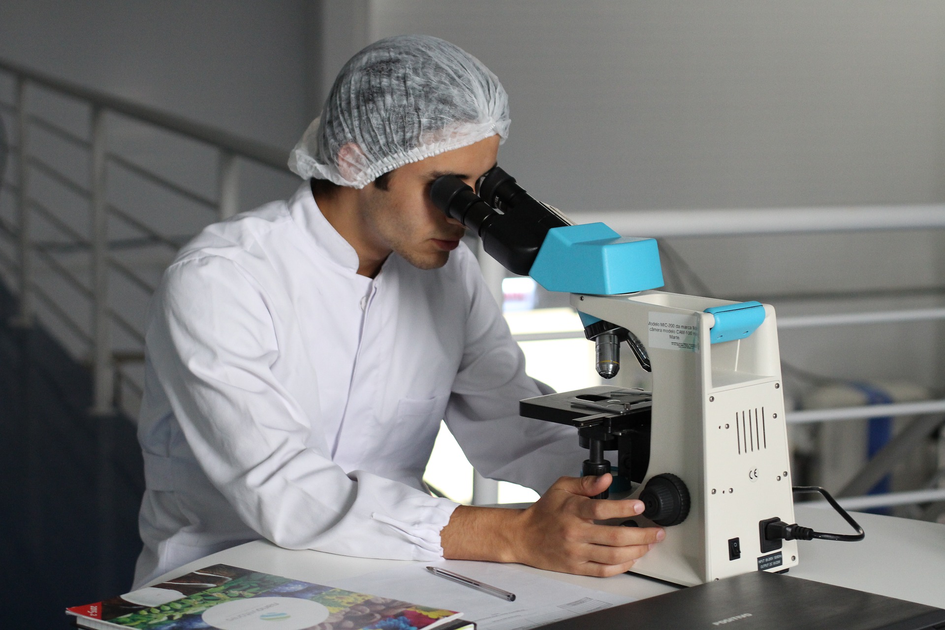 Man looking through stereo microscope