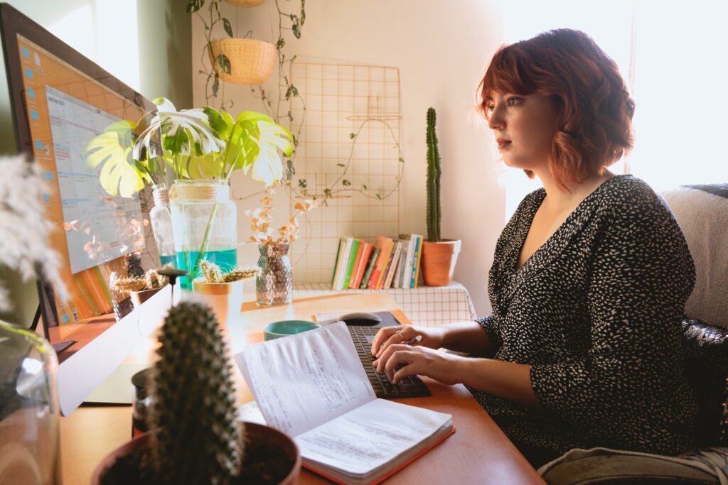 A woman typing on her computer in her home office
