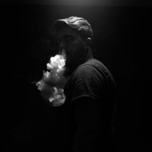 Man exhaling smoke