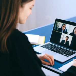 A woman on a video call with three other women