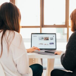 Two women looking at a laptop