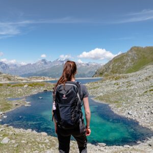 Woman in front of a Swiss mountain lake