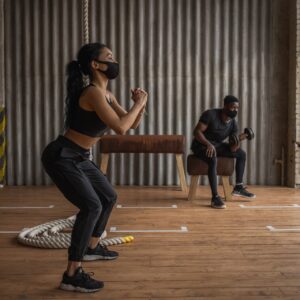 Two people exercising in a gym