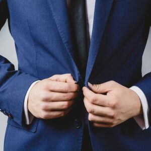 Man buttoning up suit