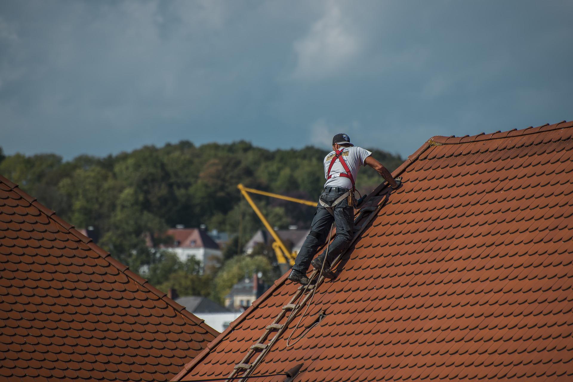 Roofer fixing roof tiles