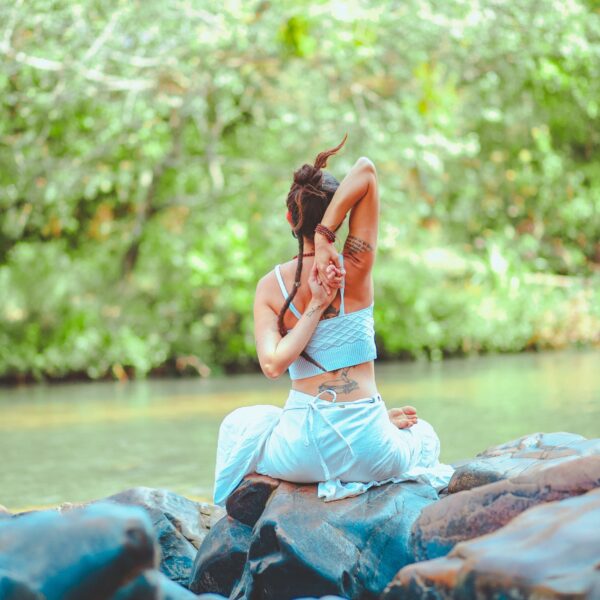 Woman stretching by water