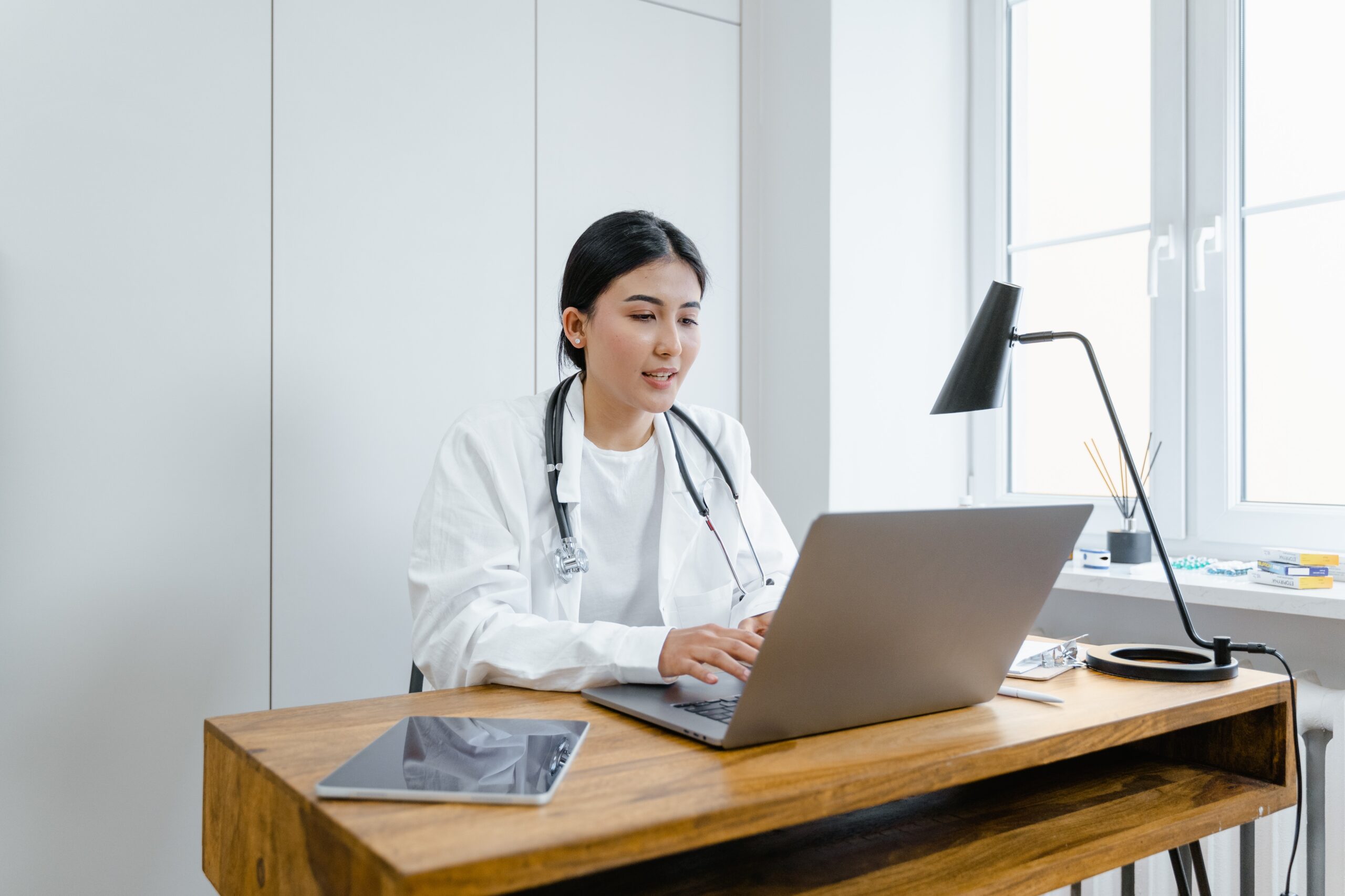 Doctor using a laptop on a desk